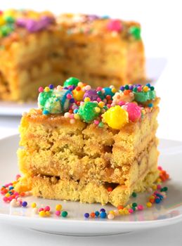 Peruvian colorful cake called Turron flavored with anis, sesame, dried fruits and honey and garnished with colorful sweets on top (Selective Focus, Focus on the front right upper edge of the cake)