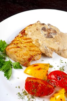 pork steak with mushroom sauce and grilled vegetables