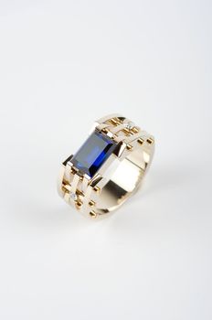 gold ring with big blue gem and smaller diamonds