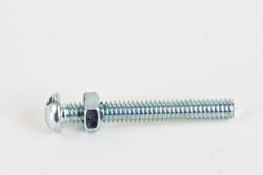 A long bolt with a screw almost to the top on a white background.