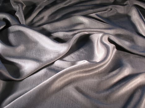 Abstract grey silk background, cloth is bedded by waves