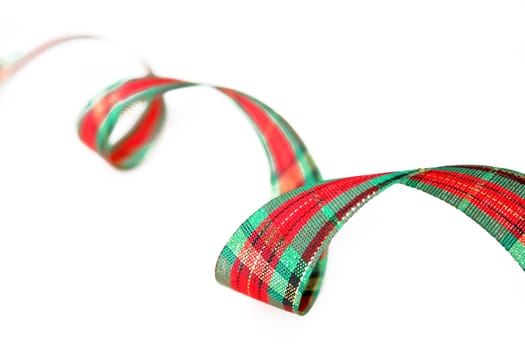 Ribbon with Christmas colors isolated on a white background. Used shallow depth of field and selective focus.