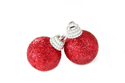 Two red Christmas ornaments made of glitter and isolated on a white background.