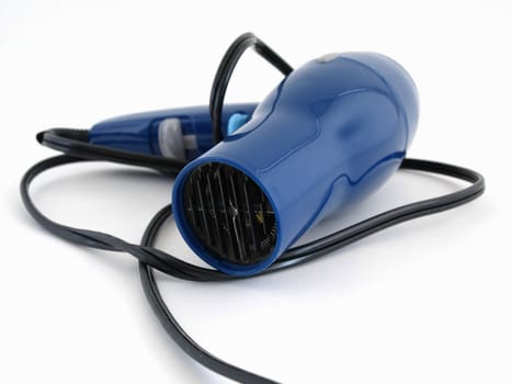 A blue hair dryer with a black cord isolated on a white background.
