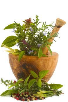 Healing herbs, spices, and edible flowers (handcarved olive tree mortar and pestle)