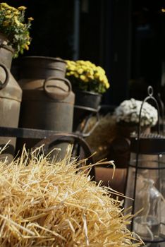 Straw with old milk-cans in the back.