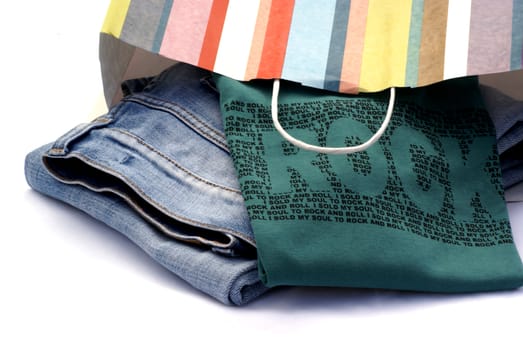 Jeans and t-shirt still in striped paper bag.