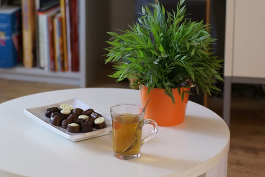 Cup of tea with some chocolates.