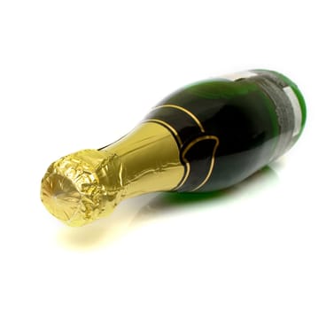 The champagne bottle lays on a white background. Isolation. Shallow DOF