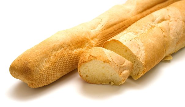 Fresh tasty bread which is cut on a part. Isolation on white. Shallow DOF.