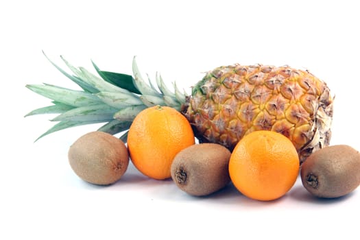 fruits oranges kiwi and ananas isolated on white background agriculture and healthy eating
