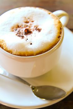 Cappuccino cup with metal spoon