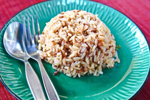 Plate of brown cooked rice from thailand