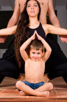 Mother, father and son enjoying yoga exercises