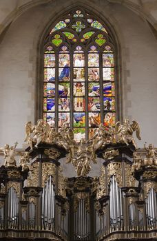 Saint Barbara church - Organ Loft and Stained glass in the church.
Saint Barbara Church in Kutna Hora is one of the most famous Gothic churches in central Europe and it is a UNESCO world heritage site. St Barbara is the patron saint of miners (among others), which was highly appropriate for a town whose wealth was based entirely upon its silver mines.
Construction began in 1388.The first architect was probably Johann Parler, son of Peter Parler, but studies say that Peter Parler had participated at least as a co-author of the draft design. Work on the building was interrupted for more than 60 years during the Hussite Wars and when work resumed in 1482, Matej Rejsek and Benedikt Rejt, two architects from Prague, assumed responsibility.
