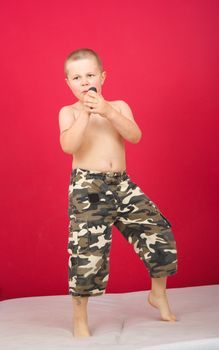 Boy sings boy in military trousers party