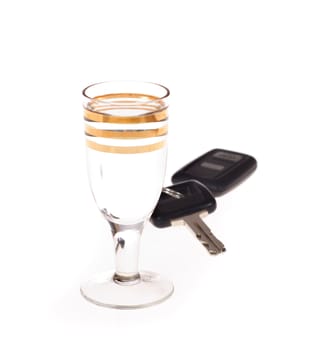 glass of vodka and keys to car photo on the white background