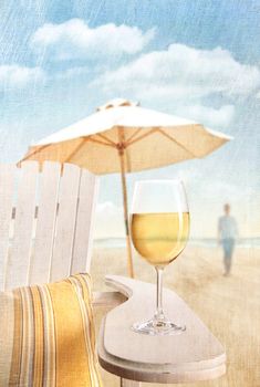 Glass of white wine on adirondack chair at the beach