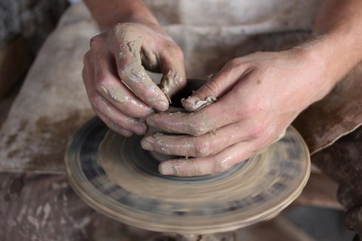 Hands of a potter. Loyalty to the traditions concept