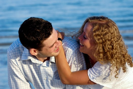 A happy woman and man in love at beach.