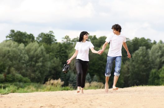 Happy young couple enjoying at beach