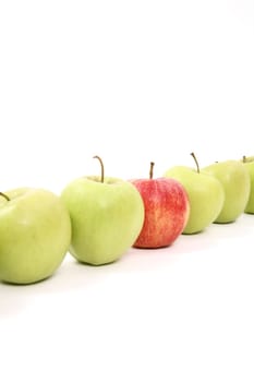 apples arranged on a white background to symbolize teamwork, leadership, discrimination............