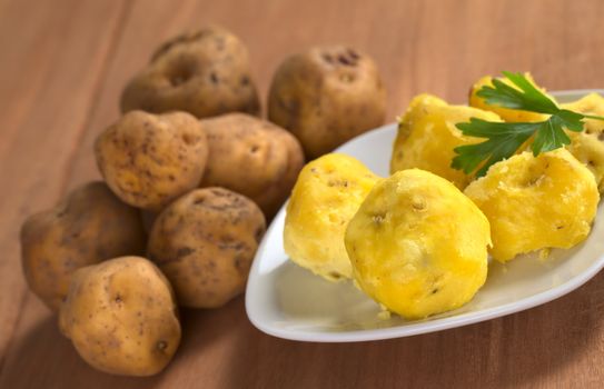 Peruvian yellow potato cooked and raw (Selective Focus, Focus on the first cooked potato)