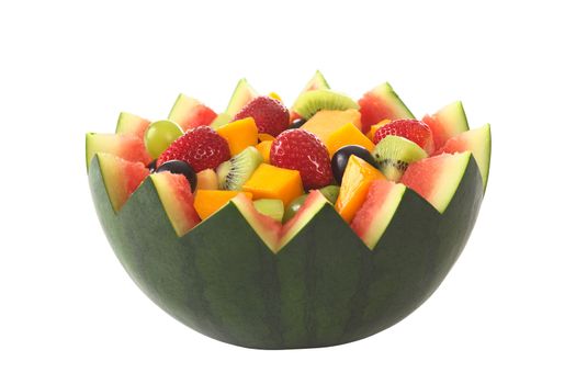 Fresh fruit salad of mango, strawberry, kiwi and grapes in a bowl from watermelon isolated on white (Selective Focus, Focus in the middle of the fruit salad) 