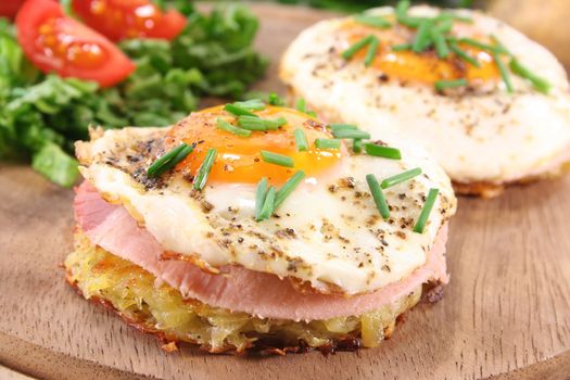 Potato pancakes with ham, egg, pepper, chives and fresh salad