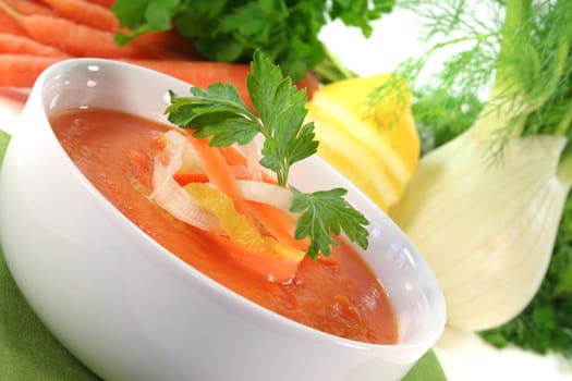 a bowl of carrot soup with fresh parsley