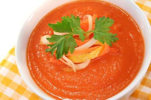 a bowl of carrot soup with fresh parsley