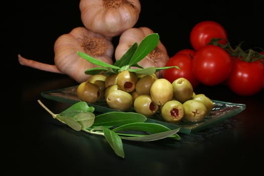 olives with olive branch and fresh tomatoes and garlic