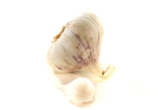 a garlic head with garlic cloves on a white background