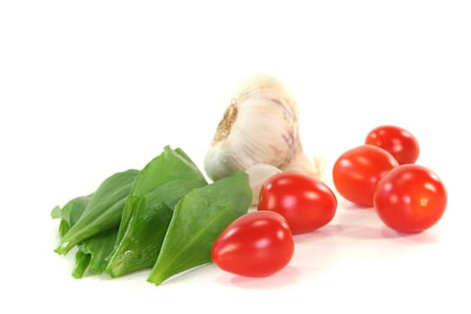 Wild garlic with tomatoes and garlic on a white background