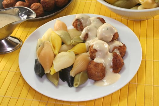 Koettbullar with Conchiglie and herb cream sauce on a plate