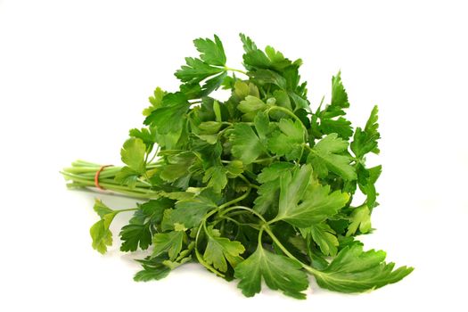 a bunch of fresh parsley on a white background