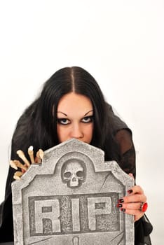 Gothic girl looking over gravestone