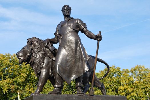 bronze statue with man and lion