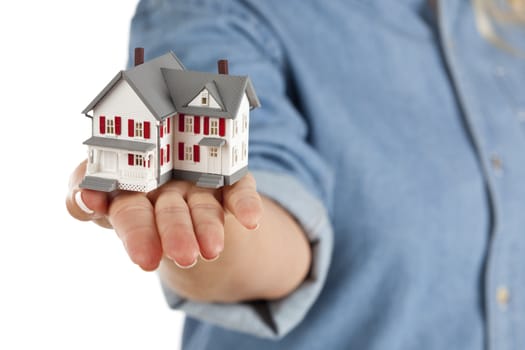 Model House in Female Hand Isolated on One Side with a White Background.