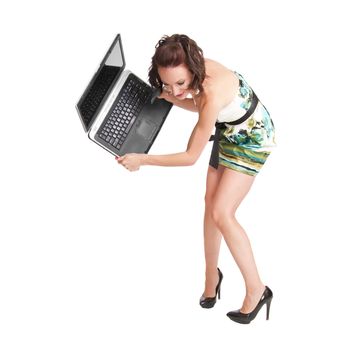 Pretty redhead woman ready to destroy a laptop computer in frustration and anger.