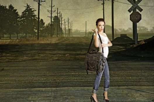 Sexy young redhead hitchhiking on a lonely country road. Composite