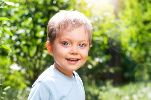 Cute 2 years old boy outdoors at sunny summer day