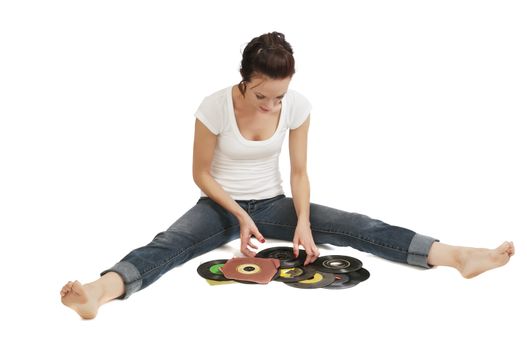 Pretty young woman looking through her 45 rpm records for one to play.
