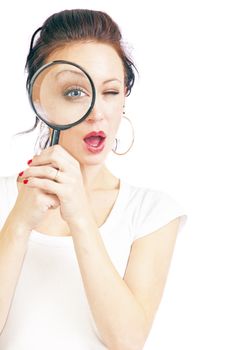 Attractive young woman looking through a magnifying glass isolated on a white background.