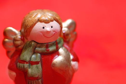 Christmas angel figurine on red background