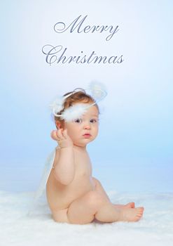 Christmas theme: Little Angel - portrait of a baby boy with angel wings. Vertical view