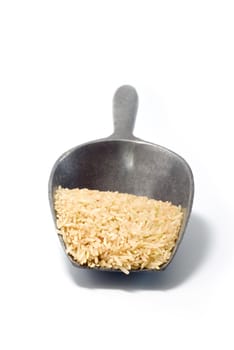 Rice in the metal spoon on white background