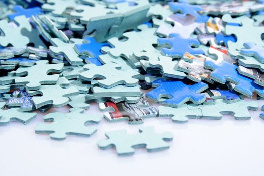 Pieces of puzzle spilled on table abstract background
