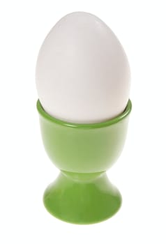white egg in eggcup, photo on the white background