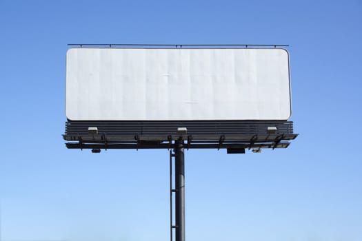 empty billboard on background of blue sky